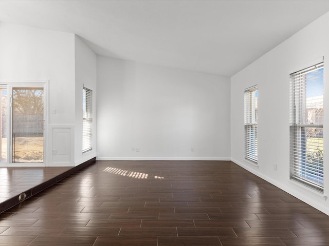 unfurnished room featuring baseboards and wood finished floors