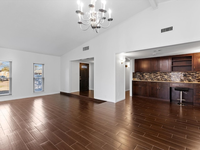 unfurnished living room featuring visible vents, built in study area, and dark wood-style flooring