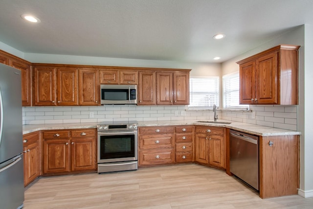 kitchen featuring a sink, brown cabinets, and stainless steel appliances