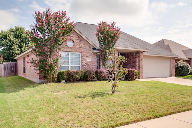 view of front of home featuring a shingled roof, concrete driveway, a front lawn, a garage, and brick siding