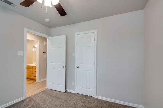 unfurnished bedroom with visible vents, baseboards, light colored carpet, and ceiling fan