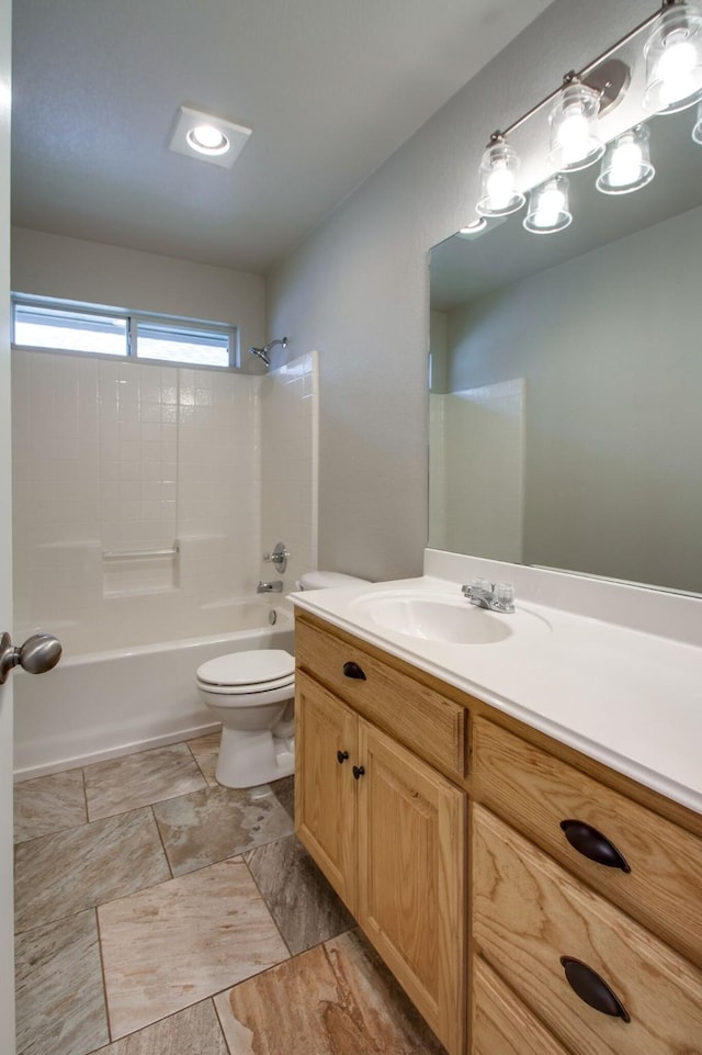 bathroom featuring vanity, toilet, and shower / bath combination