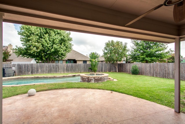 view of patio featuring a fenced backyard and a pool with connected hot tub