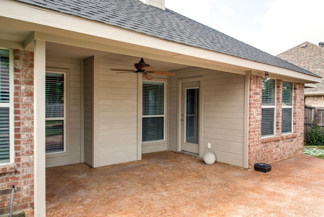 view of patio featuring a ceiling fan and fence