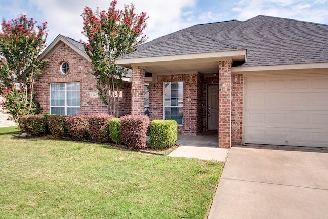 single story home with a front lawn, a garage, brick siding, and a shingled roof