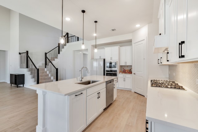 kitchen featuring a sink, light wood-type flooring, visible vents, and stainless steel appliances