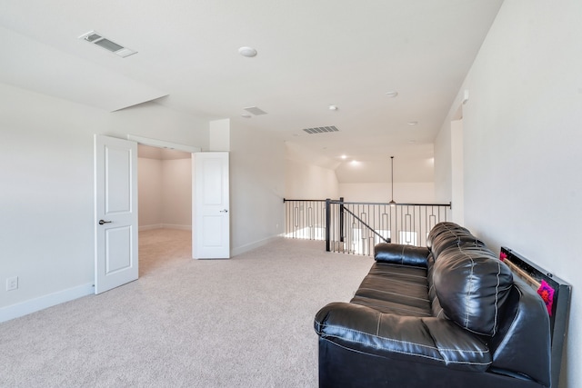 living area featuring visible vents, baseboards, and carpet