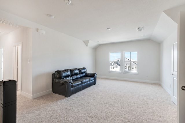 living area featuring visible vents, lofted ceiling, light colored carpet, and baseboards