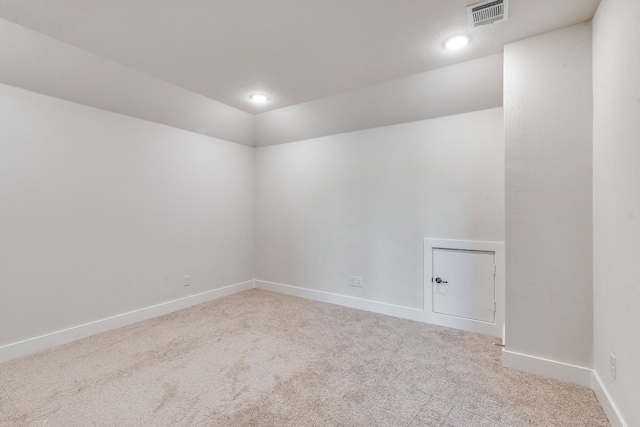 spare room featuring visible vents, baseboards, and carpet flooring