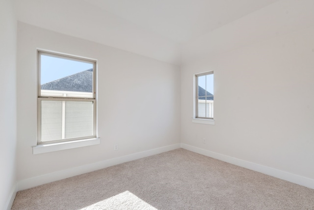 carpeted spare room with baseboards