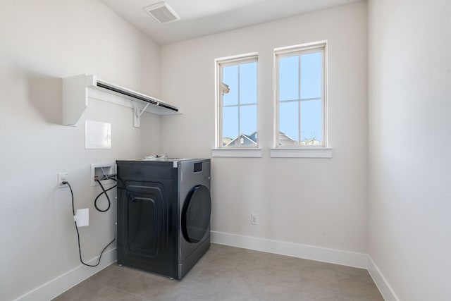 laundry room with visible vents, washer / clothes dryer, light tile patterned flooring, baseboards, and laundry area