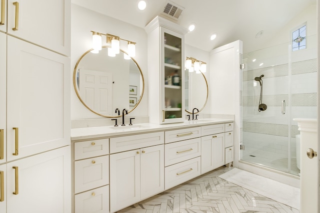 bathroom featuring a sink, visible vents, double vanity, and a shower stall