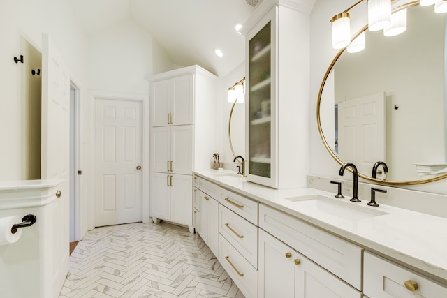 bathroom featuring a sink and double vanity