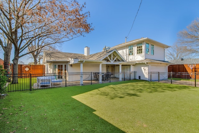 rear view of house featuring fence, a lawn, a chimney, driveway, and an attached garage