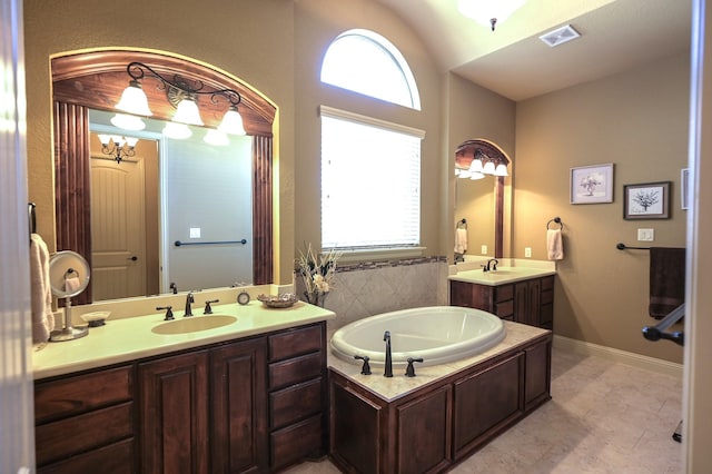 full bathroom with a sink, a garden tub, and a wealth of natural light