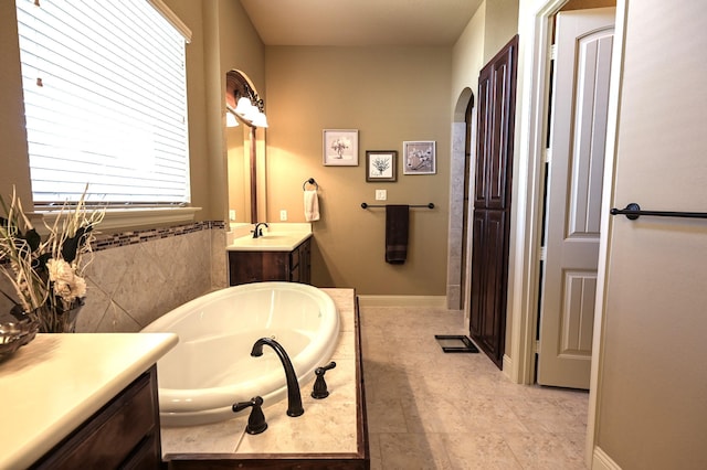 full bathroom featuring a bath and vanity