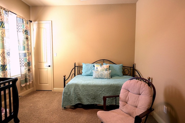 carpeted bedroom with baseboards