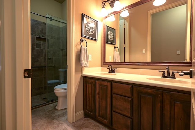 full bath with a sink, toilet, double vanity, and a shower stall