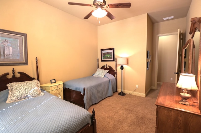 carpeted bedroom with a ceiling fan, baseboards, and visible vents