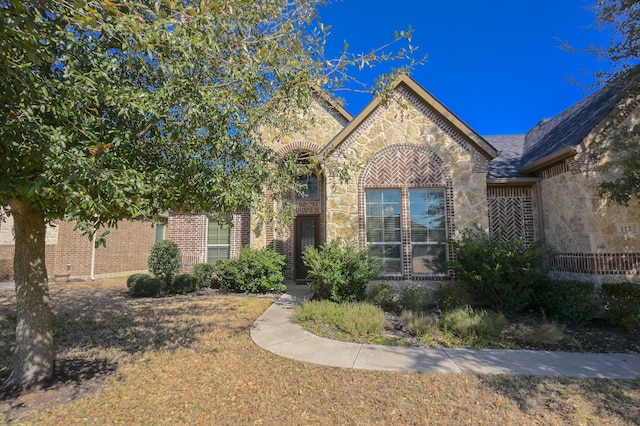 view of front of house featuring brick siding and stone siding