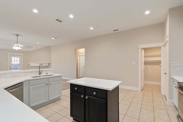 kitchen with dark cabinetry, visible vents, a sink, light countertops, and dishwasher