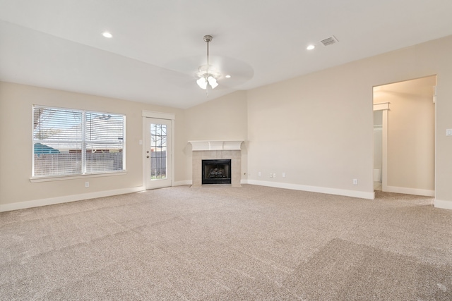 unfurnished living room featuring a fireplace, a ceiling fan, visible vents, and light carpet