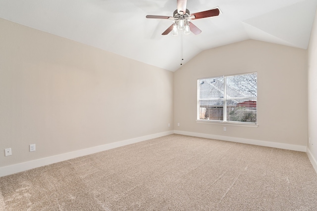 empty room featuring baseboards, lofted ceiling, light colored carpet, and a ceiling fan