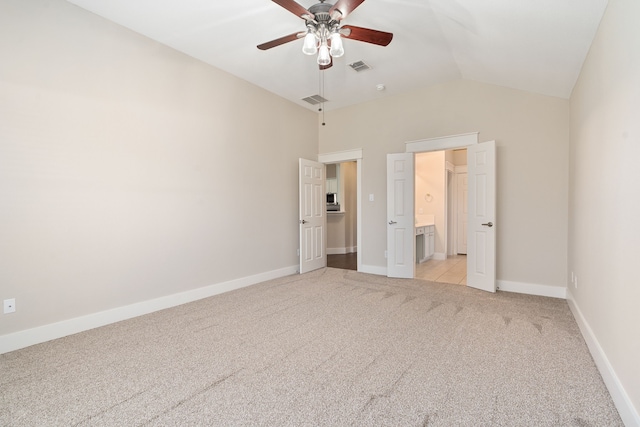 unfurnished bedroom featuring baseboards, visible vents, light carpet, and lofted ceiling