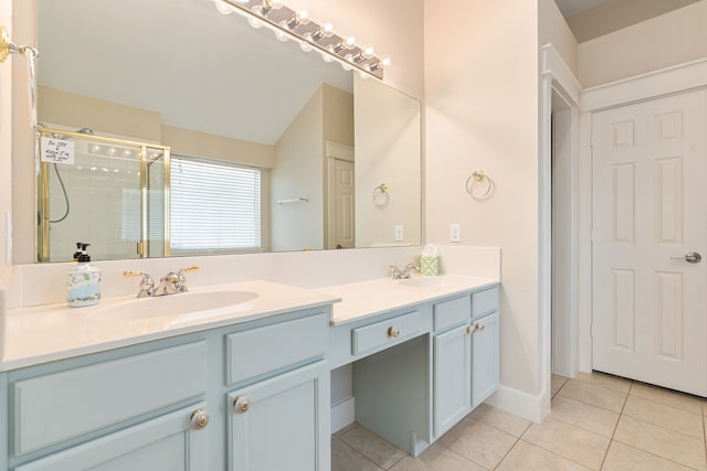 full bathroom with tile patterned flooring, a tile shower, double vanity, and a sink