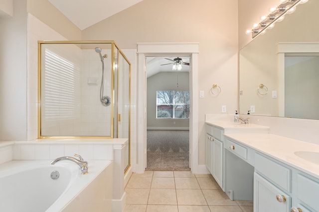 full bathroom featuring lofted ceiling, double vanity, a stall shower, tile patterned floors, and a bath