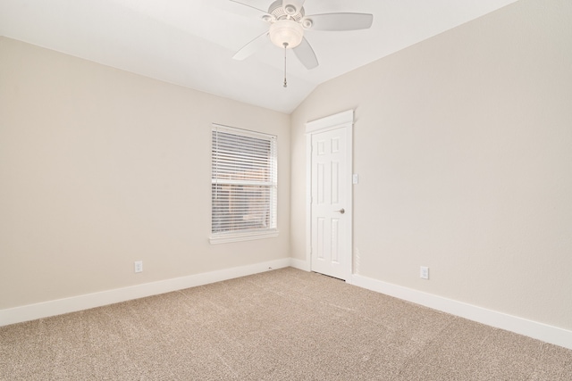 unfurnished room with baseboards, lofted ceiling, light colored carpet, and ceiling fan