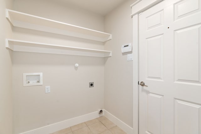 laundry area featuring electric dryer hookup, light tile patterned floors, baseboards, hookup for a washing machine, and laundry area