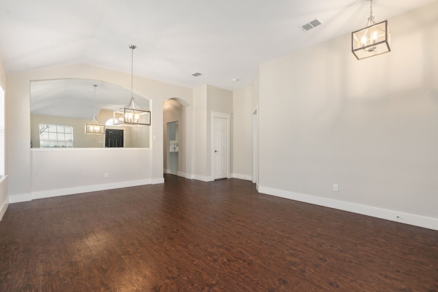 unfurnished living room with visible vents, baseboards, a chandelier, dark wood-style flooring, and vaulted ceiling