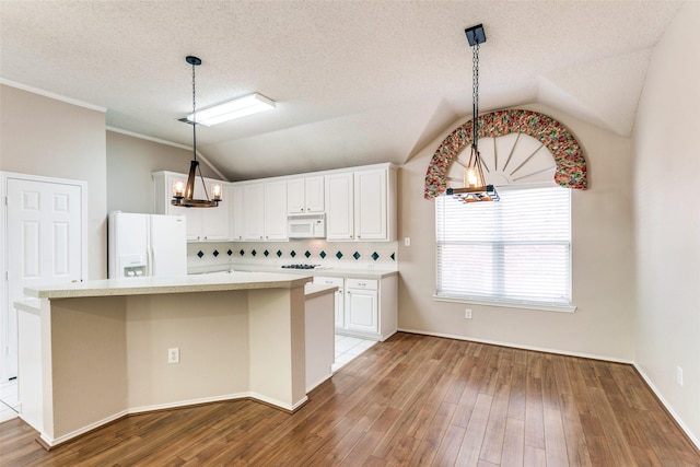 kitchen with lofted ceiling, wood finished floors, a notable chandelier, white cabinets, and white appliances