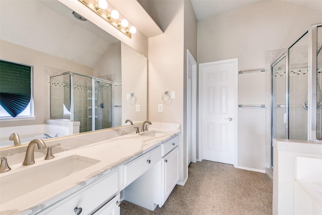 full bath featuring a sink, a stall shower, double vanity, and a tub