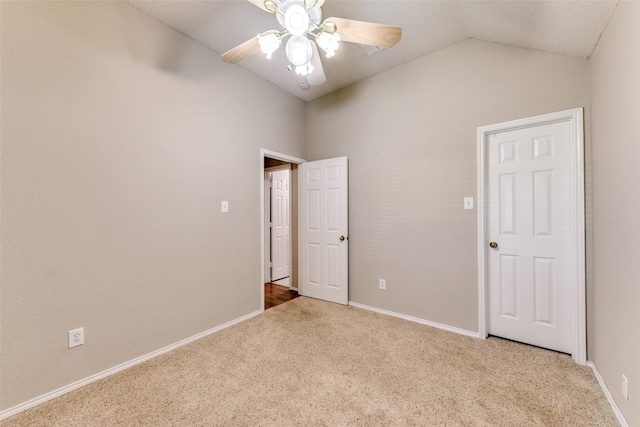 unfurnished bedroom with lofted ceiling, baseboards, carpet floors, and ceiling fan