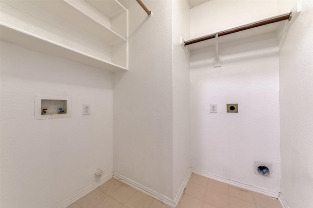 clothes washing area with baseboards, laundry area, electric dryer hookup, washer hookup, and hookup for a gas dryer