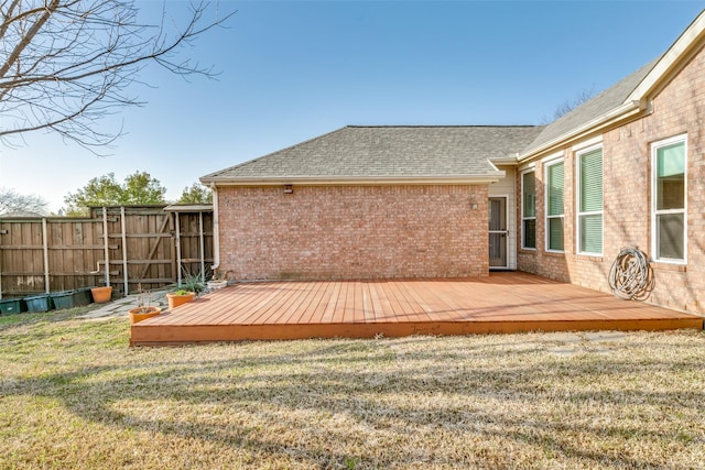 wooden deck featuring a yard and fence