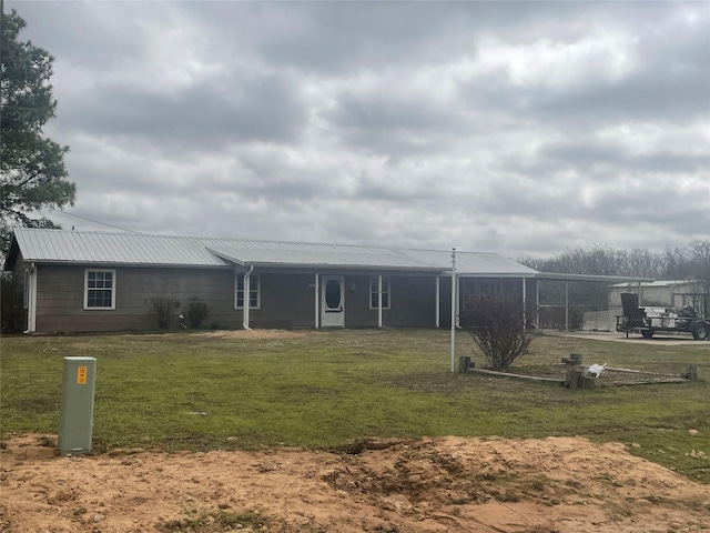 view of front of property featuring a front yard and metal roof