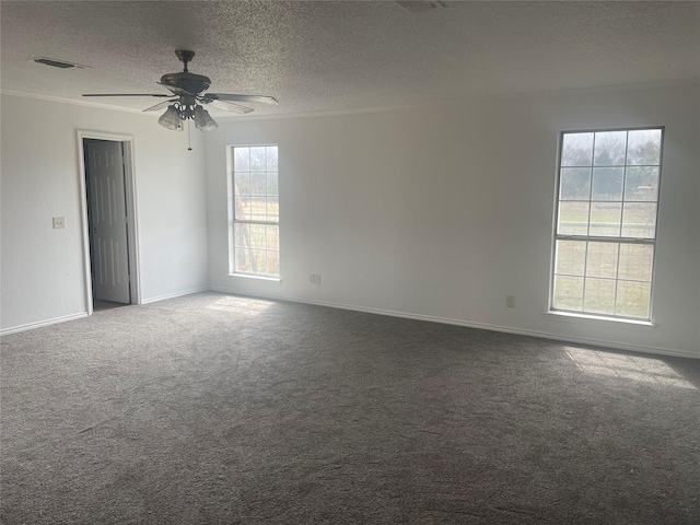 carpeted empty room featuring visible vents, baseboards, ceiling fan, ornamental molding, and a textured ceiling