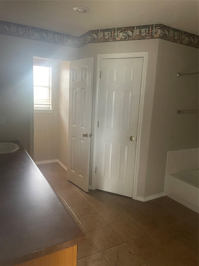 interior space with tile patterned flooring and baseboards