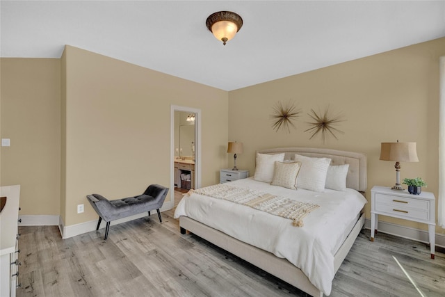 bedroom with baseboards and light wood-style floors