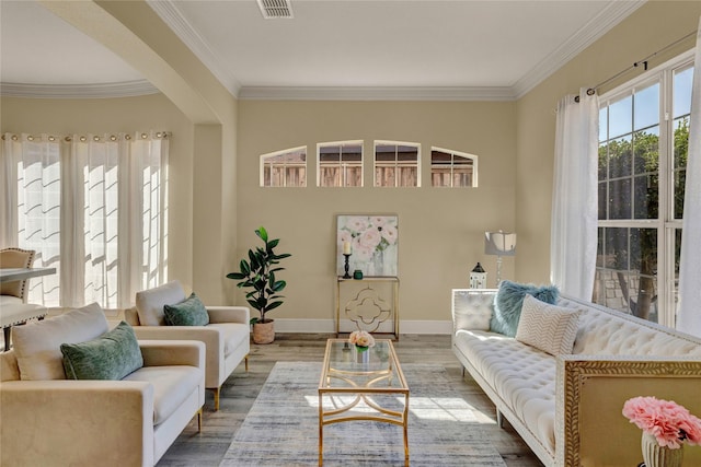 living room featuring baseboards, arched walkways, wood finished floors, and crown molding