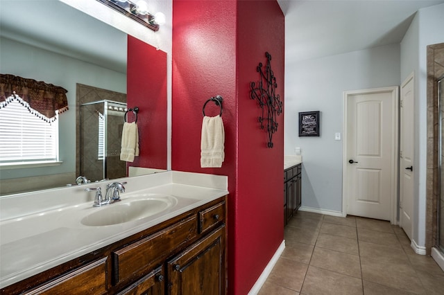 full bathroom featuring tile patterned flooring, a stall shower, vanity, and baseboards