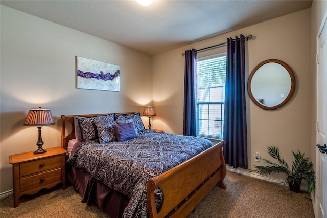 bedroom with carpet flooring and baseboards