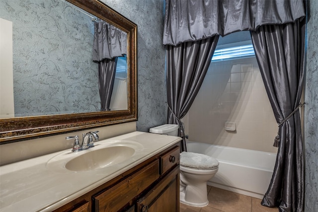 bathroom featuring tile patterned flooring, toilet, vanity, and bathing tub / shower combination