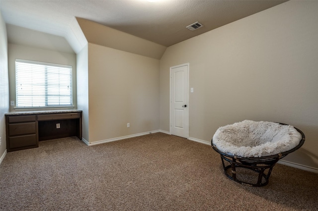 sitting room featuring visible vents, baseboards, lofted ceiling, and carpet