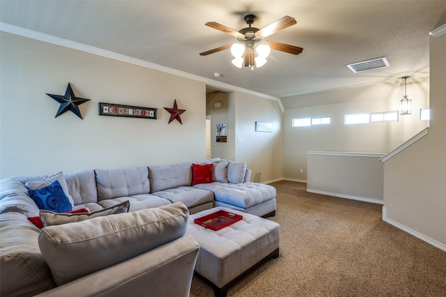 living area with visible vents, ceiling fan, baseboards, carpet, and ornamental molding