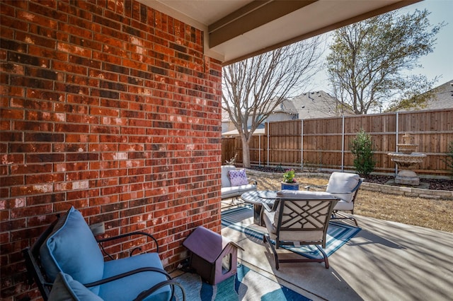 view of patio featuring fence