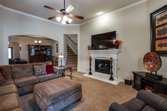 living room featuring carpet, a fireplace with raised hearth, arched walkways, ornamental molding, and stairs